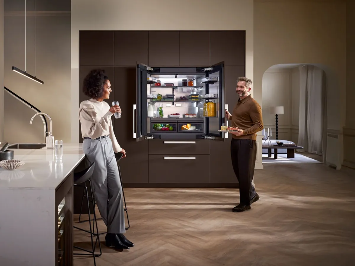 Couple in a luxury kitchen with a panel-ready built-in refrigerator