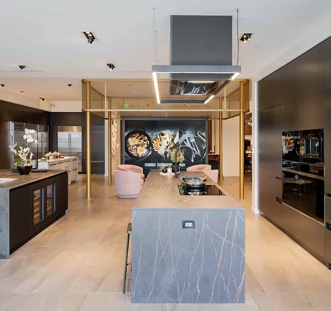 Luxury open kitchen with a stone island and brass details
