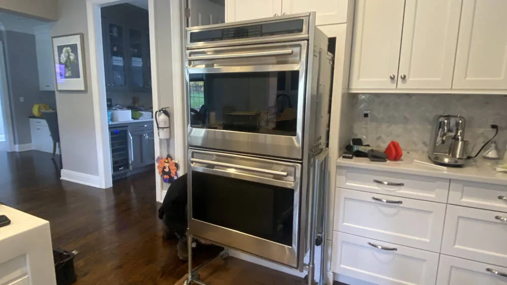 Wolf double wall oven pulled out of the cabinet for service